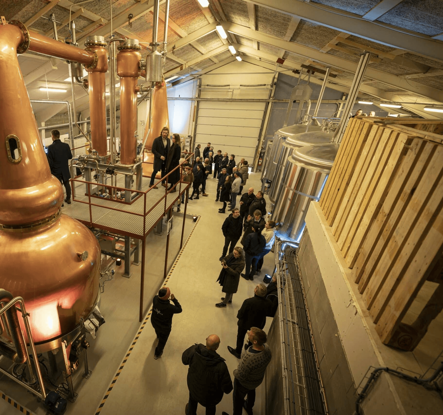 People gathered inside a distillery